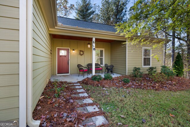 view of exterior entry featuring a porch