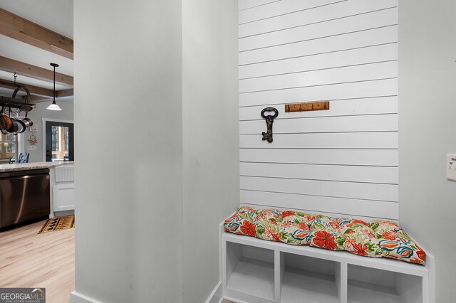 mudroom with beamed ceiling and light hardwood / wood-style floors