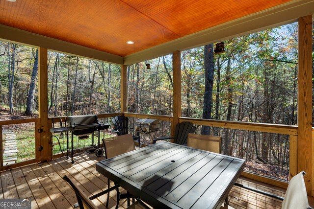 sunroom / solarium with plenty of natural light and wooden ceiling