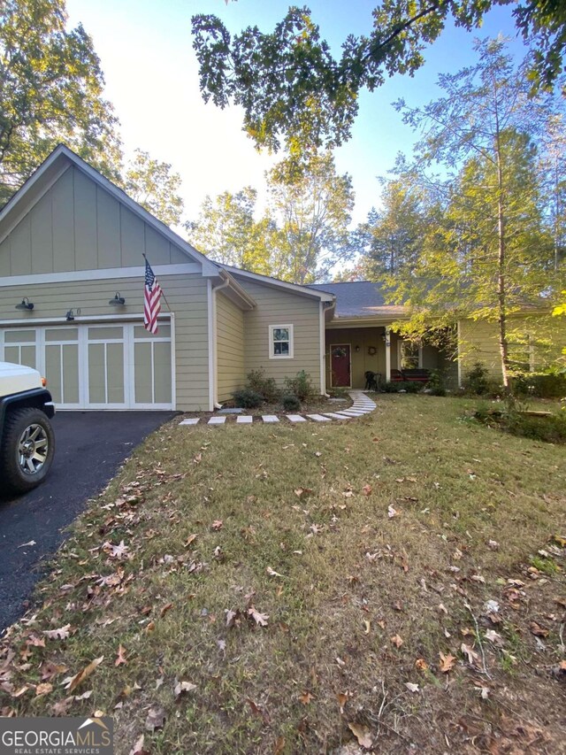 view of front of property with a garage and a front yard