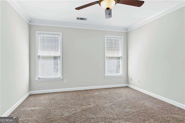 carpeted spare room with ceiling fan and ornamental molding