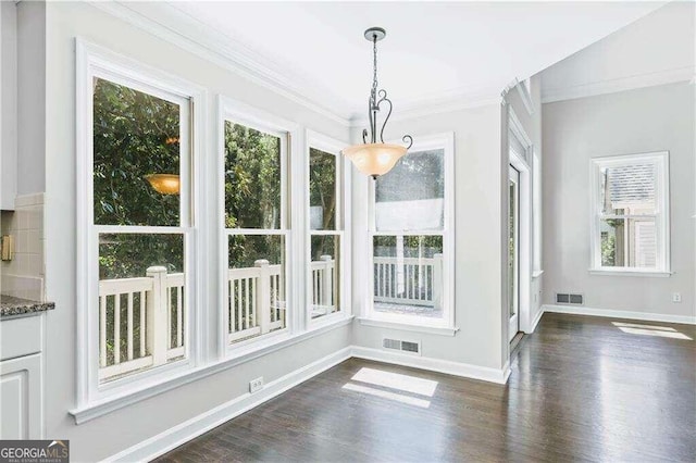 unfurnished dining area with dark hardwood / wood-style floors and crown molding