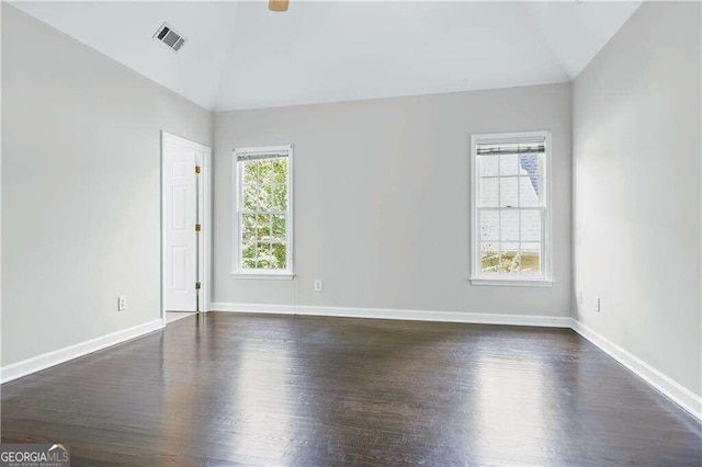 unfurnished room featuring dark hardwood / wood-style floors and lofted ceiling