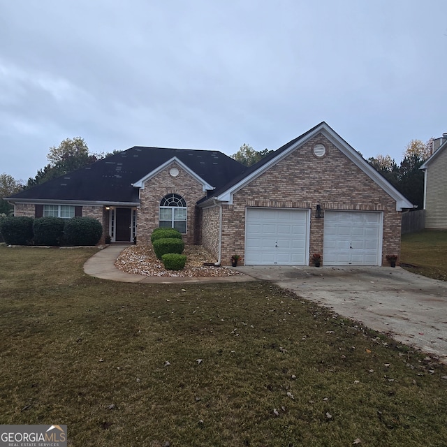 single story home featuring a garage and a front yard