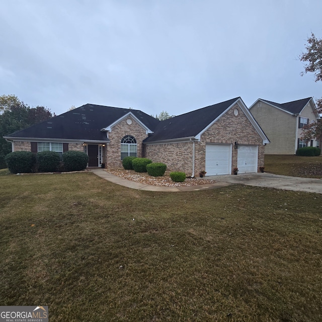 single story home featuring a garage and a front yard