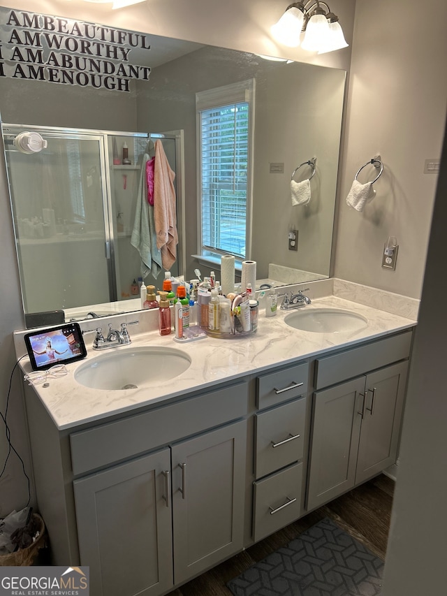 bathroom with vanity, wood-type flooring, and a shower with shower door