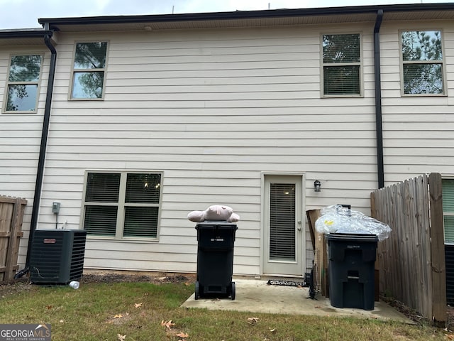 rear view of house with central AC