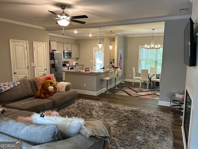 living room with dark hardwood / wood-style floors, ceiling fan with notable chandelier, and crown molding