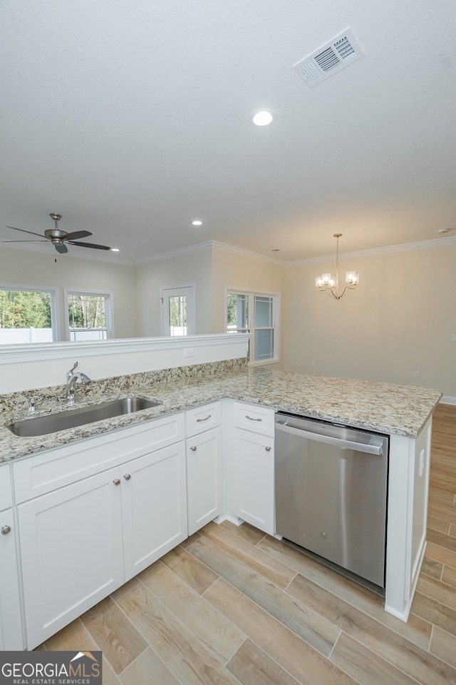 kitchen featuring stainless steel dishwasher, plenty of natural light, sink, and white cabinetry