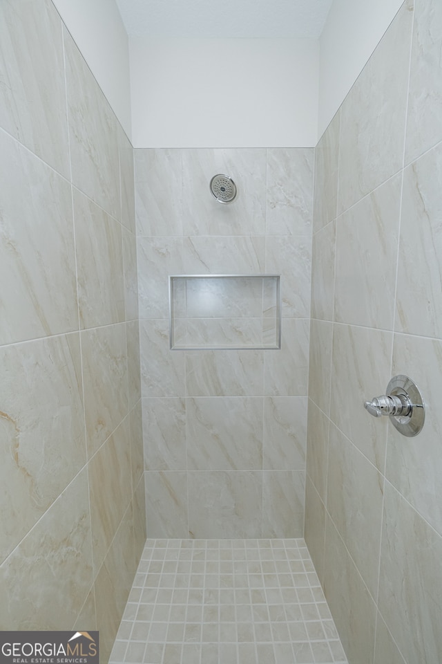 bathroom with tiled shower