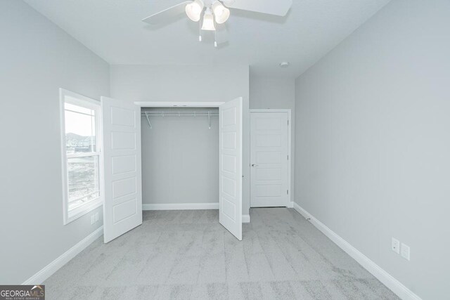 184 The Villas Way, Kingsland, GA 31548 - unfurnished bedroom featuring a closet, light carpet, and ceiling fan