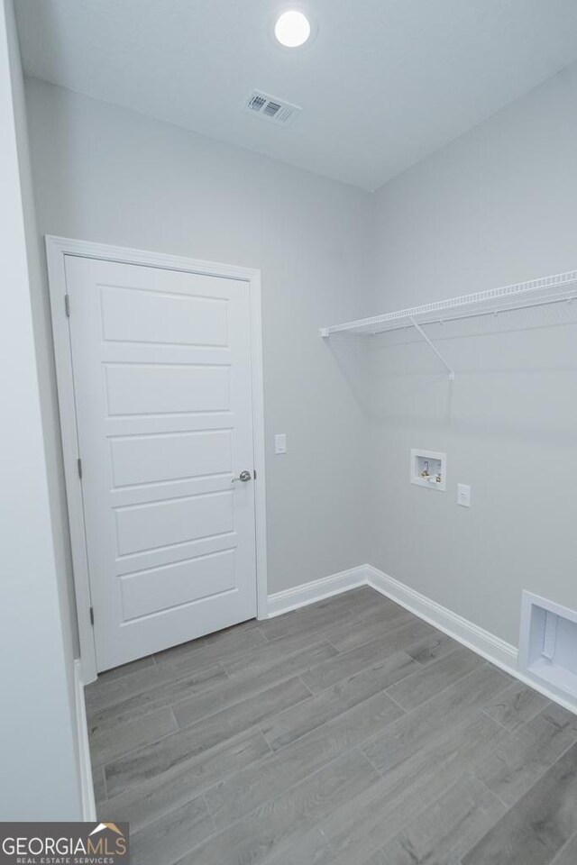 184 The Villas Way, Kingsland, GA 31548 - laundry area featuring hookup for a washing machine and light hardwood / wood-style flooring