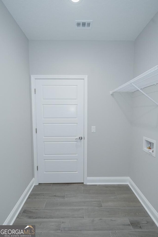 184 The Villas Way, Kingsland, GA 31548 - clothes washing area featuring hardwood / wood-style floors and washer hookup