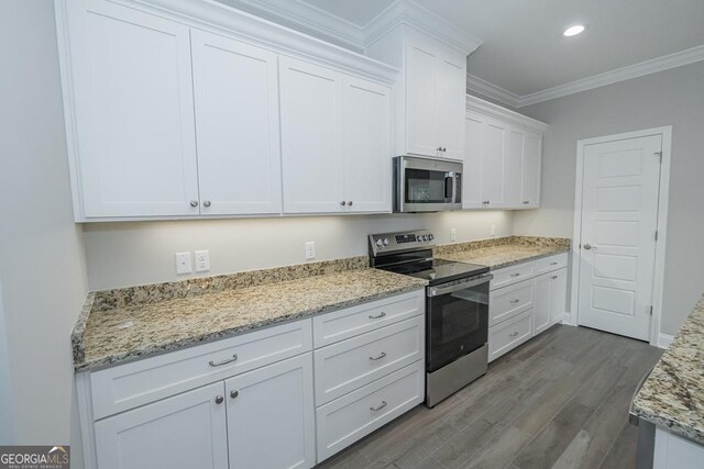 184 The Villas Way, Kingsland, GA 31548 - kitchen with white cabinetry, light stone counters, appliances with stainless steel finishes, ornamental molding, and dark hardwood / wood-style flooring