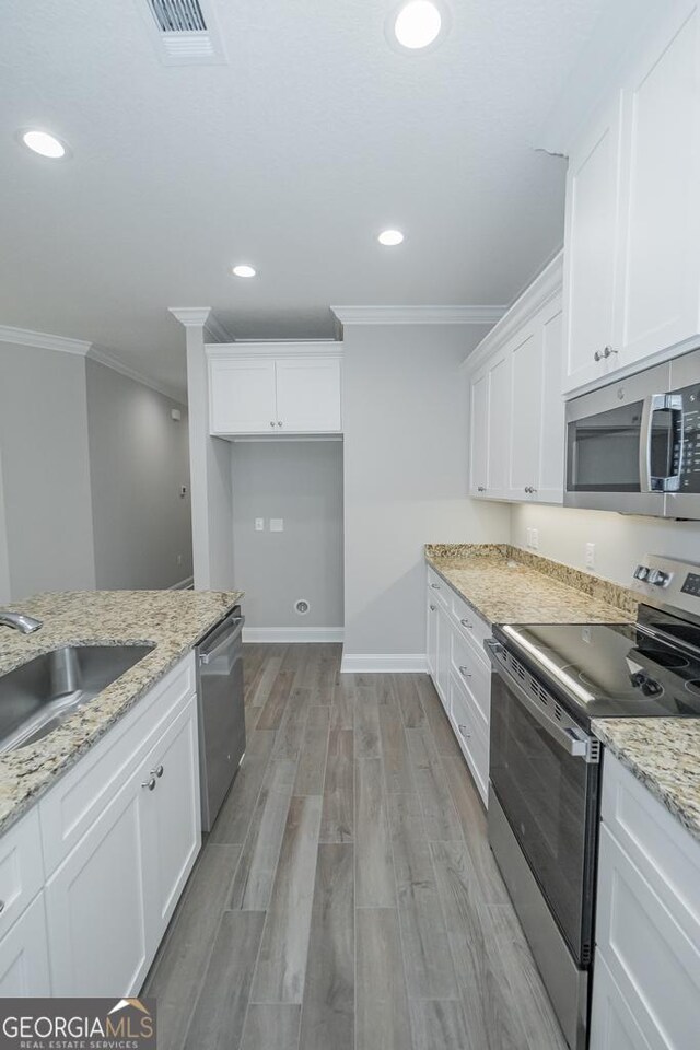 184 The Villas Way, Kingsland, GA 31548 - kitchen featuring light stone counters, light hardwood / wood-style flooring, sink, white cabinetry, and appliances with stainless steel finishes