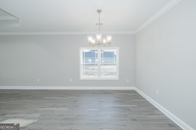 184 The Villas Way, Kingsland, GA 31548 - empty room with light wood-type flooring, an inviting chandelier, and ornamental molding