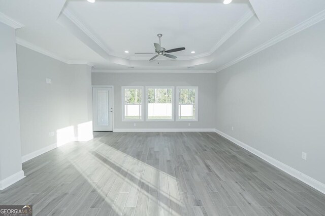184 The Villas Way, Kingsland, GA 31548 - empty room featuring ornamental molding, light hardwood / wood-style floors, ceiling fan, and a raised ceiling