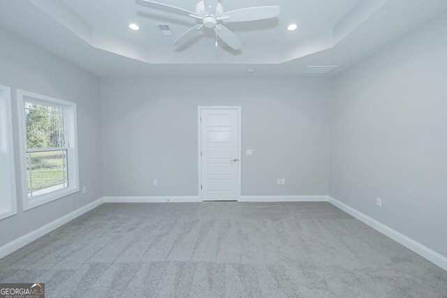 184 The Villas Way, Kingsland, GA 31548 - empty room featuring a tray ceiling, light colored carpet, and ceiling fan