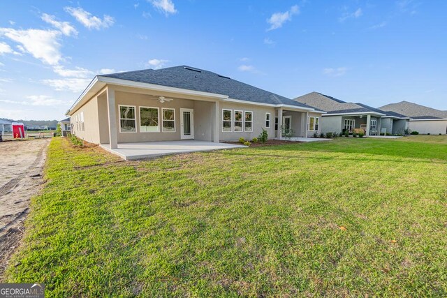 184 The Villas Way, Kingsland, GA 31548 - rear view of property featuring ceiling fan, a yard, and a patio area