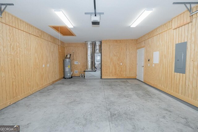 184 The Villas Way, Kingsland, GA 31548 - garage featuring water heater, wood walls, electric panel, and a garage door opener