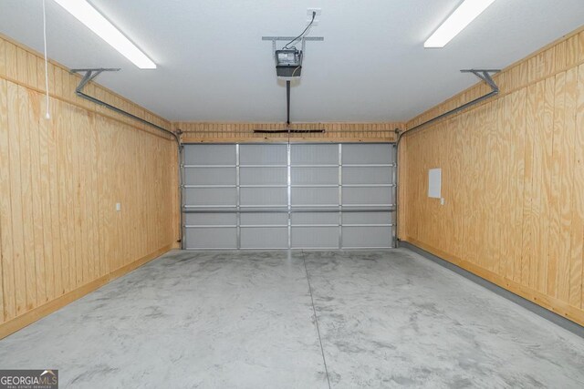 184 The Villas Way, Kingsland, GA 31548 - garage featuring wood walls and a garage door opener