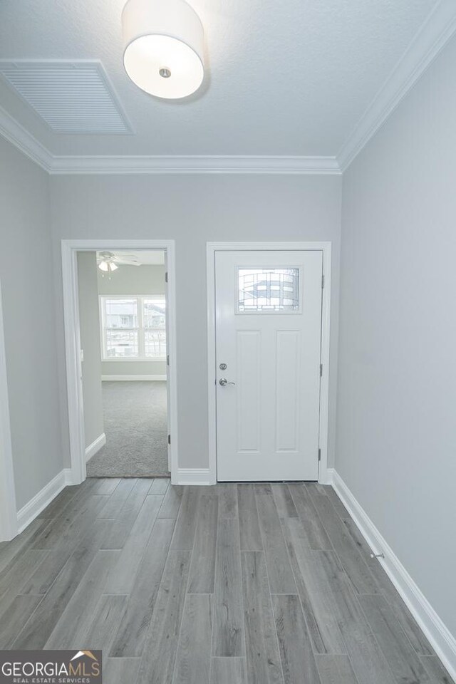 184 The Villas Way, Kingsland, GA 31548 - foyer entrance featuring ceiling fan, crown molding, and light hardwood / wood-style flooring