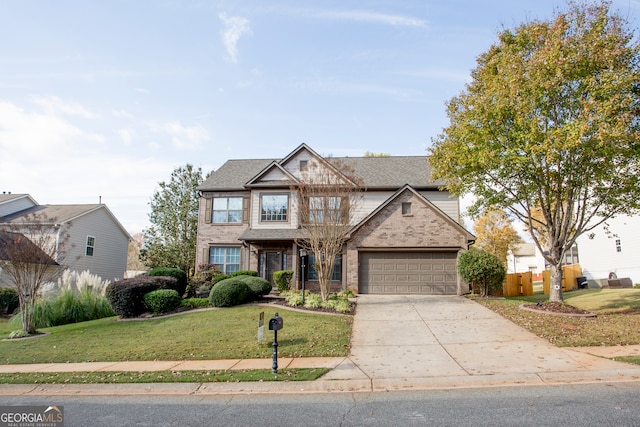 view of front of property featuring a garage and a front yard