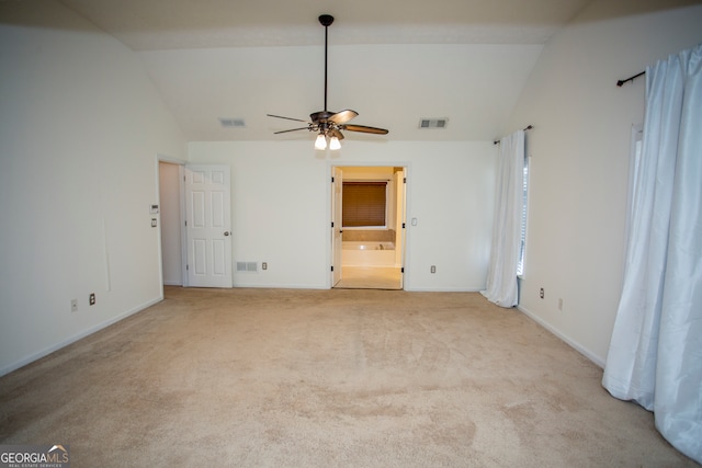 carpeted spare room featuring ceiling fan and vaulted ceiling