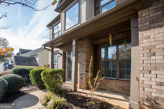 view of exterior entry with a porch