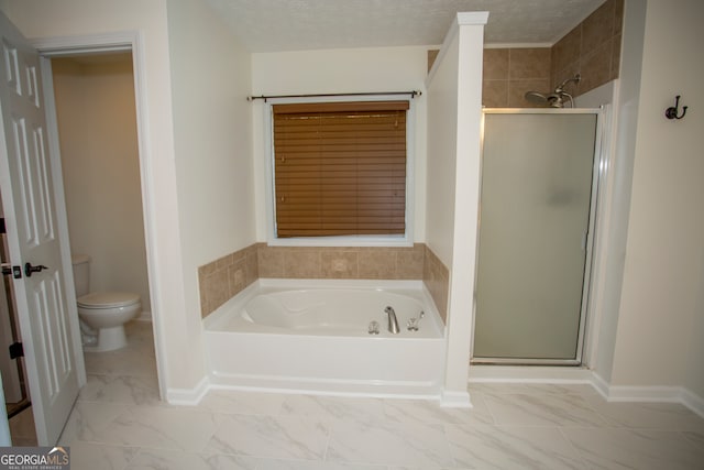 bathroom featuring toilet, plus walk in shower, and a textured ceiling