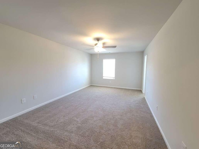 unfurnished room featuring light carpet and ceiling fan