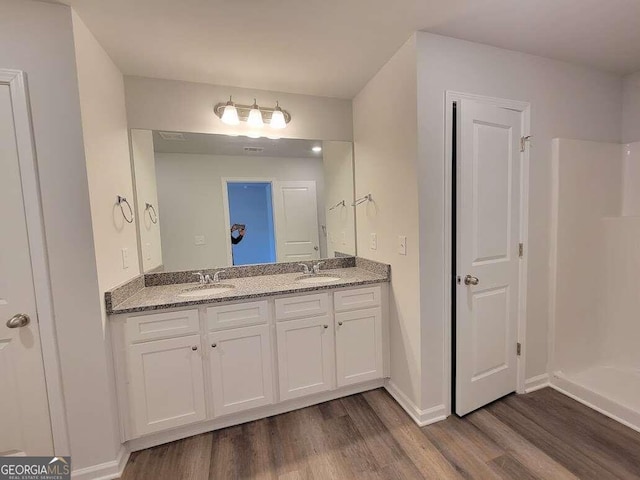 bathroom with hardwood / wood-style floors and vanity