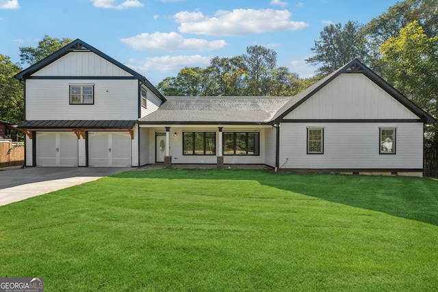 view of front of property with a garage and a front lawn