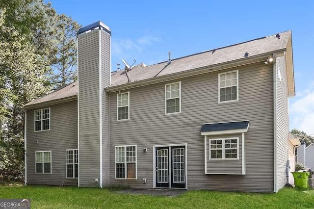 back of house featuring a yard