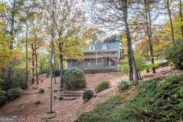 back of property featuring stairs