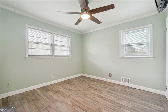 unfurnished room featuring light hardwood / wood-style floors, ceiling fan, and crown molding