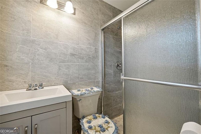 bathroom with walk in shower, tile walls, vanity, and toilet