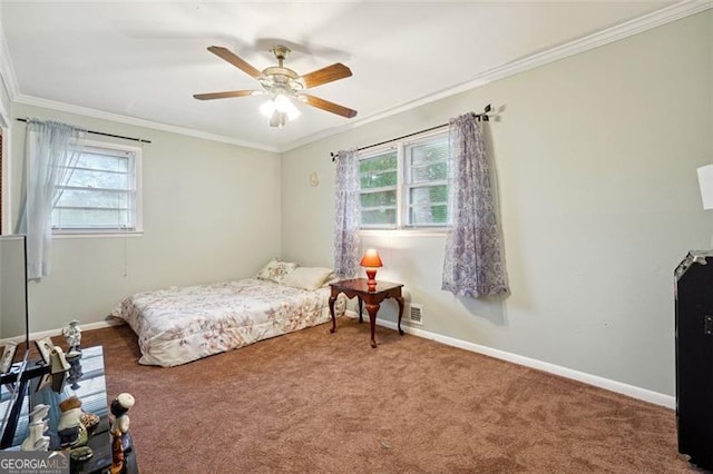 bedroom featuring ornamental molding, multiple windows, ceiling fan, and carpet