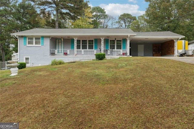 single story home with a porch, a front yard, and a carport