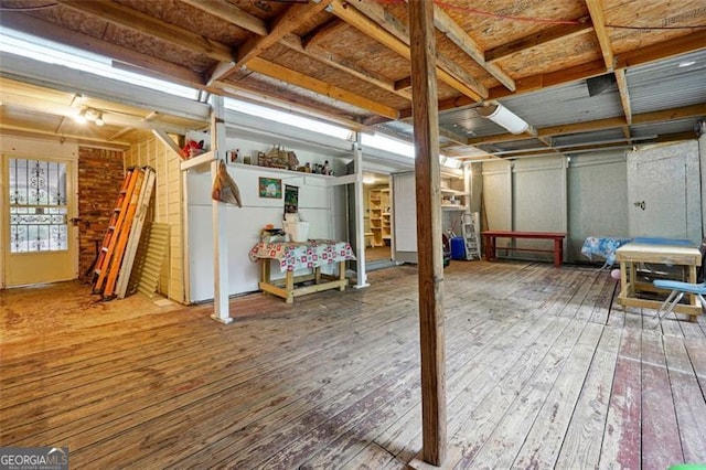 basement with hardwood / wood-style flooring