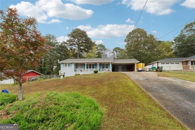 view of front of house featuring covered porch, a garage, and a front yard