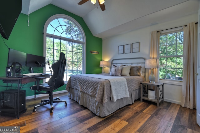 bedroom featuring ceiling fan, multiple windows, and dark hardwood / wood-style floors