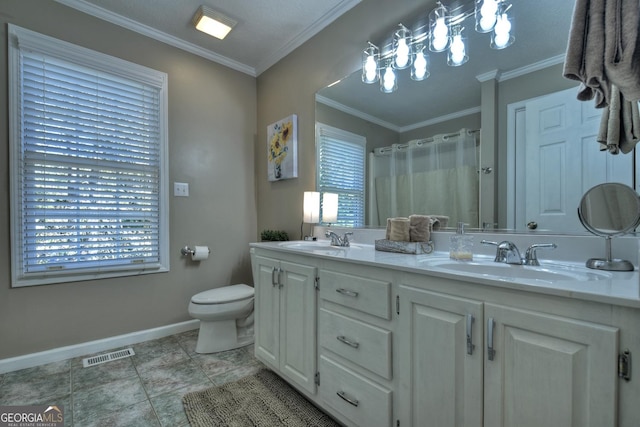 bathroom featuring crown molding, visible vents, a sink, and double vanity