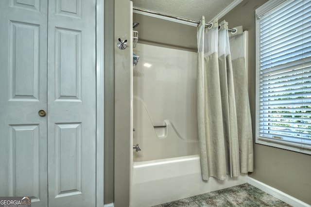 bathroom featuring a textured ceiling, shower / bath combination with curtain, and crown molding