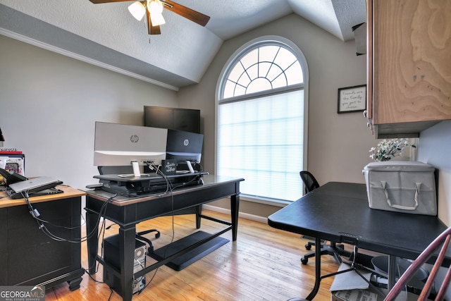 office area featuring lofted ceiling, a textured ceiling, ceiling fan, and light hardwood / wood-style flooring