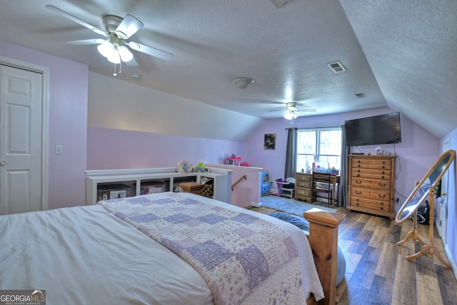 bedroom featuring lofted ceiling, hardwood / wood-style flooring, and ceiling fan