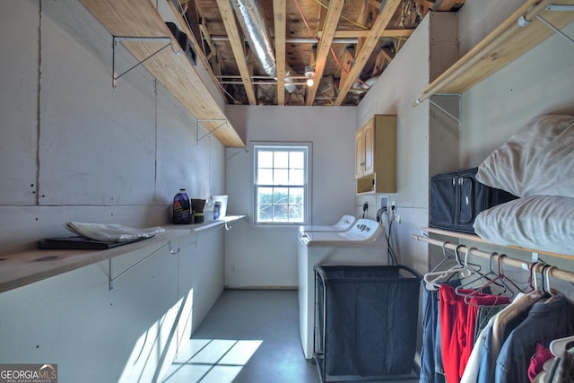 washroom with cabinet space and washing machine and dryer