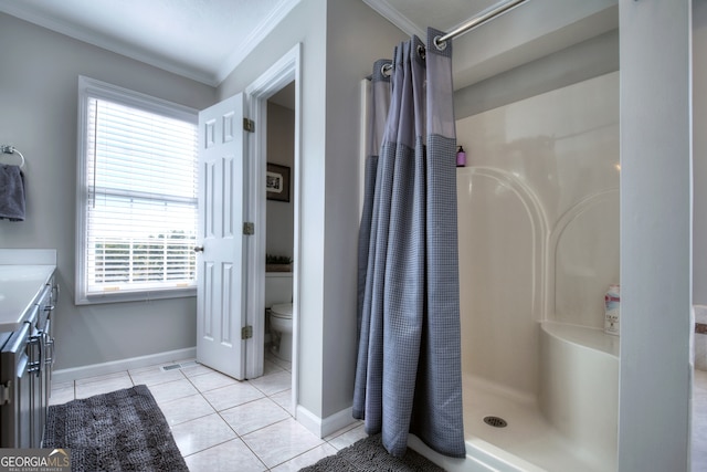 bathroom with ornamental molding, a shower with curtain, tile patterned floors, and a healthy amount of sunlight