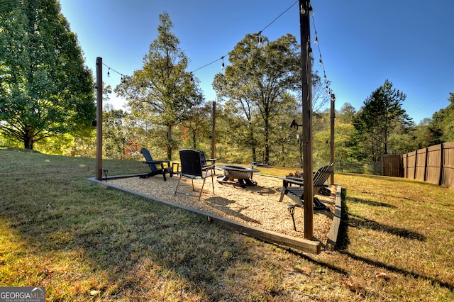 view of yard with a fire pit