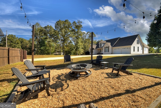 exterior space with a garage and an outdoor fire pit